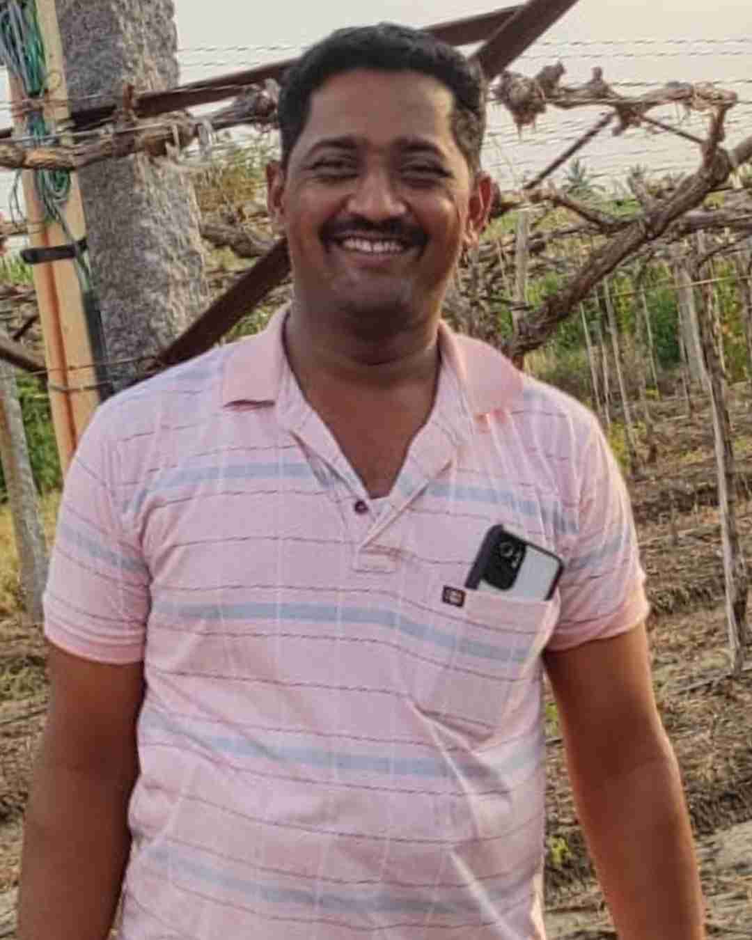 An onion grower from Nashik checking soil moisture on his field.